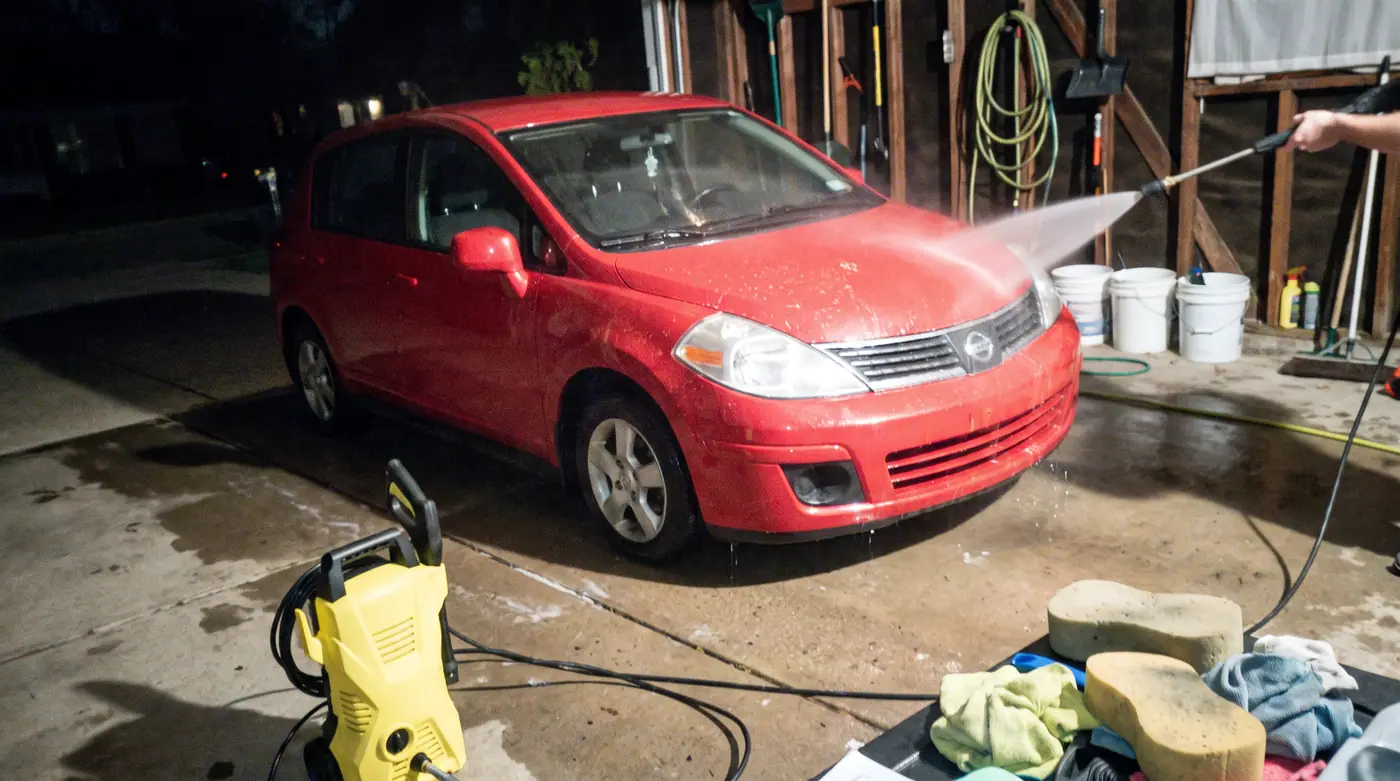 Red car pressure wash water spray cleaning snapshot