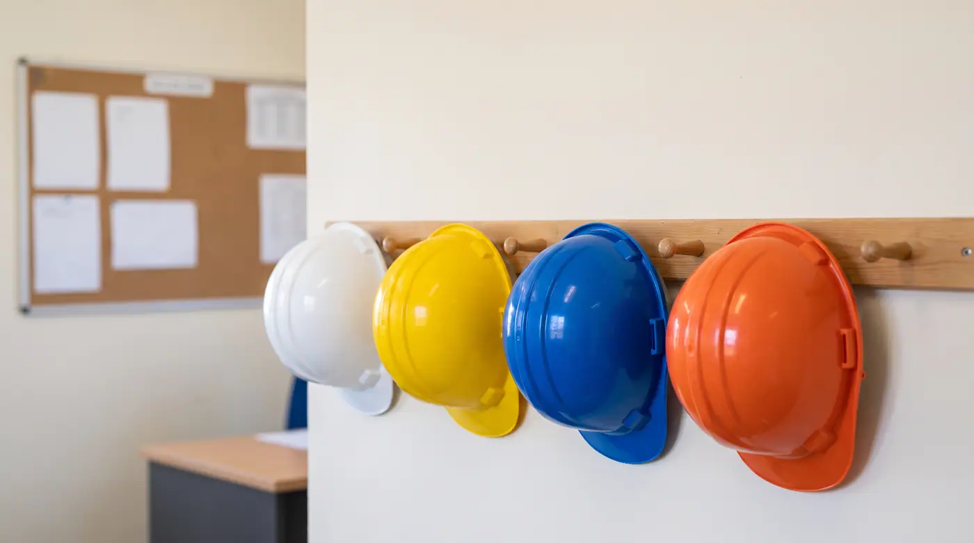 Safety helmets hard hats row wall industrial site office clean