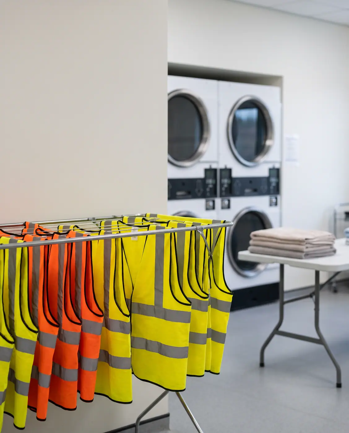 High-visibility reflective safety vests drying rack laundry room
