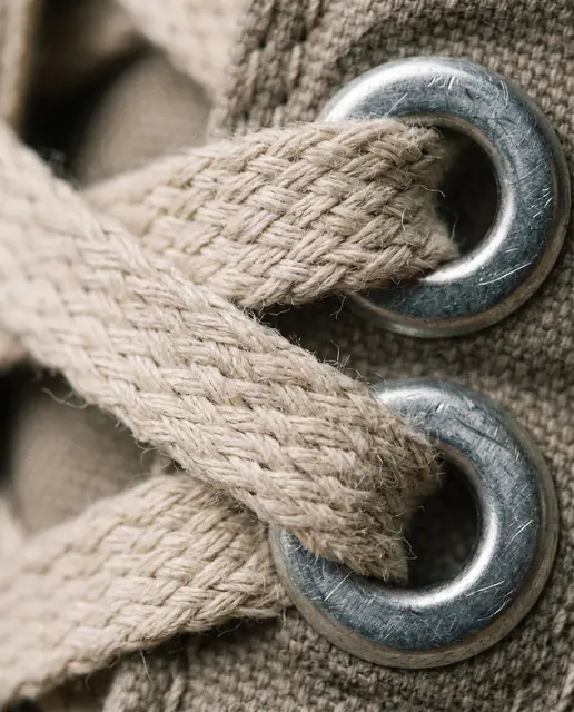 Macro canvas sneaker laces metal eyelets worn texture