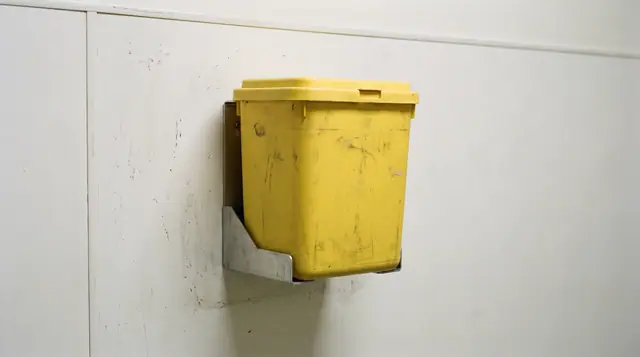 Yellow sharps disposal container, glove dispenser, clinical wall