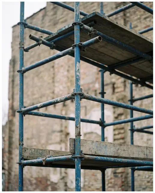 Blue scaffolding structure detailed straight on overcast daylight