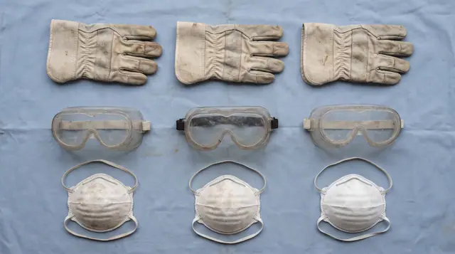 Protective gloves goggles dust mask pale blue background grid