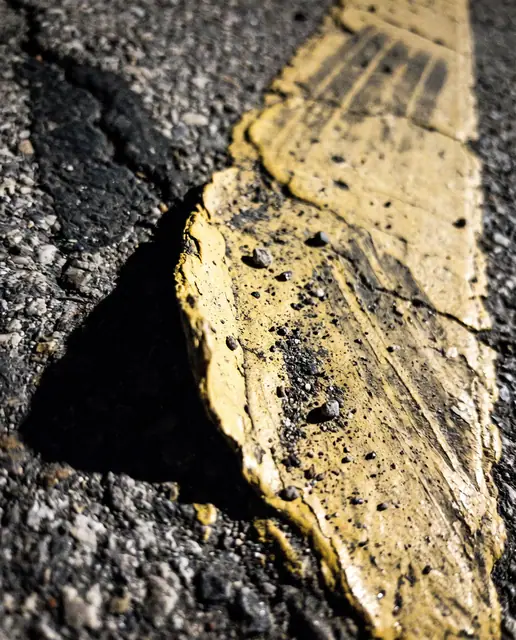 Yellow paint marking asphalt tyre wear shadow low angle