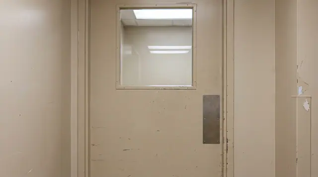 Closed isolation room anteroom door observation window hospital