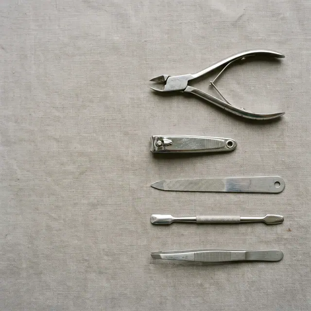 Nail clippers set flat lay, neutral surface, copy space, top view