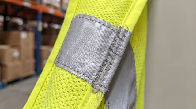 High-visibility reflective safety vest fabric edge stitching